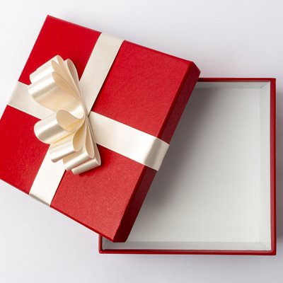 Red gift box made of cardboard with bow